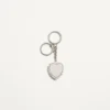 Coeur Hyperbole Taschenanhänger mit Schlüsselanhänger aus Metall, Kunststoff und Kristallen Coeur Hyperbole Taschenanhänger mit Schlüsselanhänger aus Metall, Kunststoff und Kristallen