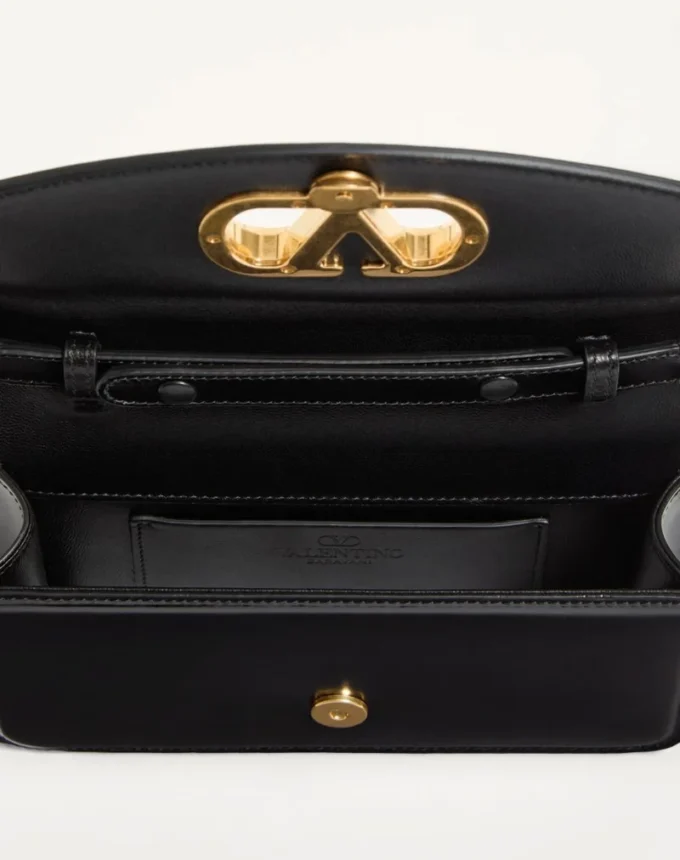 Valentino Garavani Vain Clutch aus glänzendem Kalbsleder Valentino Garavani Vain Clutch aus glänzendem Kalbsleder