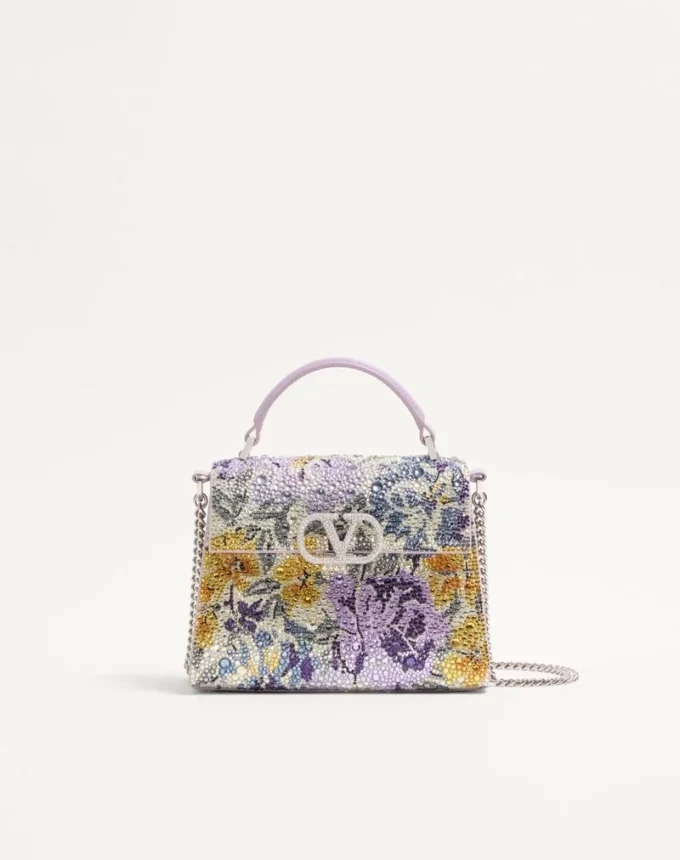 Valentino Garavani Vsling Mini-Handtasche mit Flowerism-Strassmotiv und Juwelenlogo Valentino Garavani Vsling Mini-Handtasche mit Flowerism-Strassmotiv und Juwelenlogo