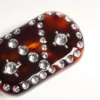 Vlogo Signature Haarspange aus Harz, Metall und Kristallen